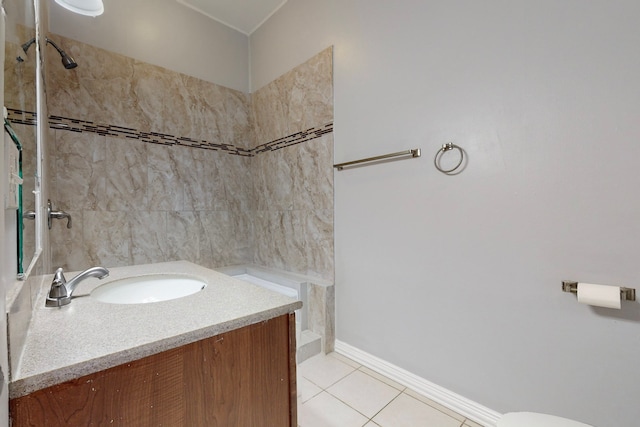 bathroom with vanity, a tile shower, and tile patterned floors