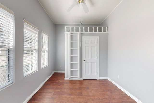 spare room featuring crown molding, dark hardwood / wood-style flooring, and ceiling fan