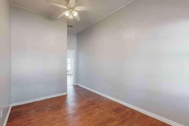 empty room featuring ceiling fan and dark wood-type flooring