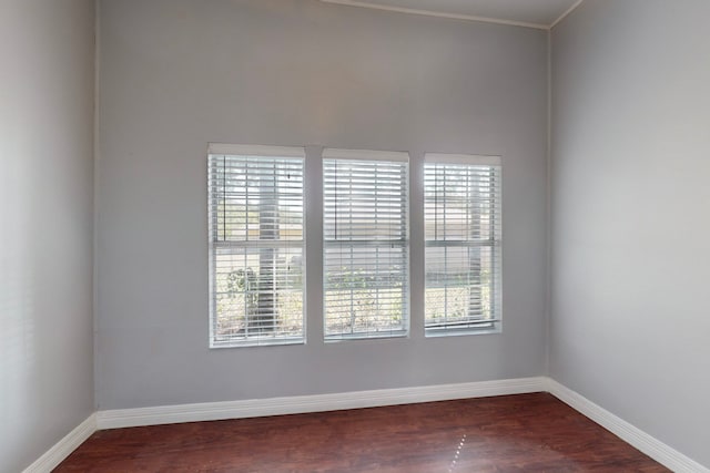 unfurnished room with dark wood-type flooring