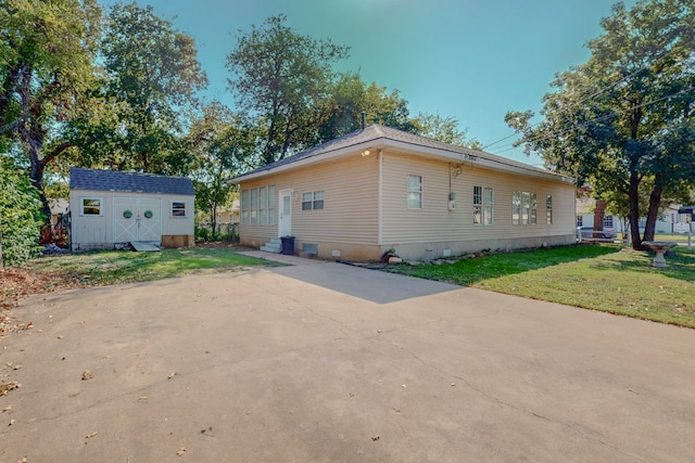 view of property exterior featuring a lawn and a shed