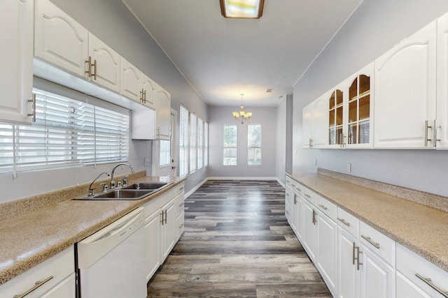 kitchen featuring white dishwasher, hanging light fixtures, sink, white cabinetry, and dark hardwood / wood-style floors