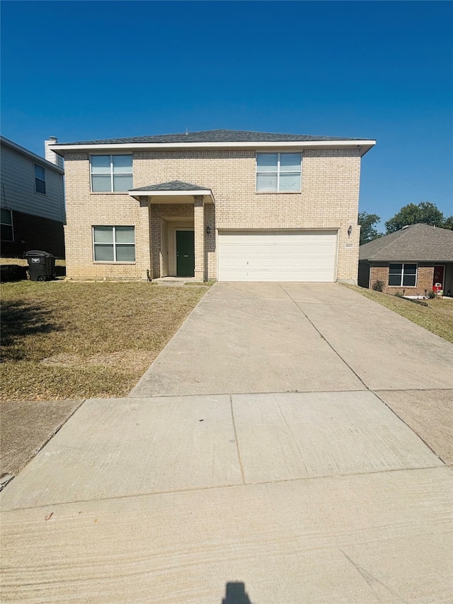 view of front of home featuring a front lawn and a garage