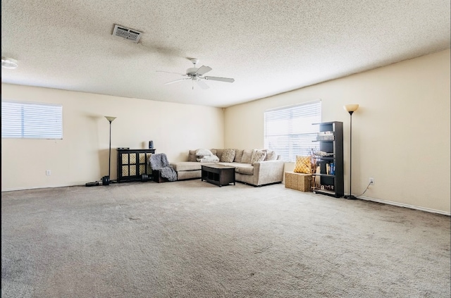 unfurnished living room featuring ceiling fan, light carpet, and a textured ceiling