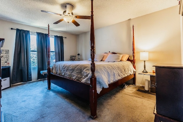 carpeted bedroom with ceiling fan and a textured ceiling