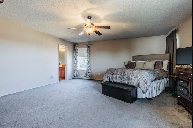 bedroom with connected bathroom, a textured ceiling, carpet flooring, and ceiling fan