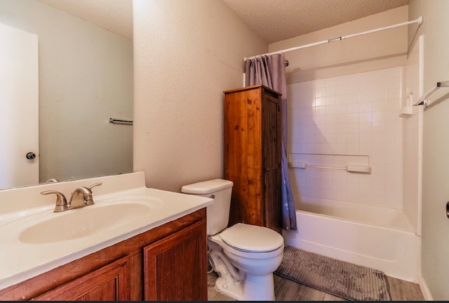 full bathroom with toilet, shower / bath combination with curtain, hardwood / wood-style floors, vanity, and a textured ceiling