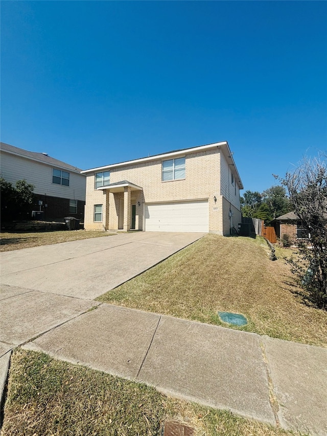 view of front facade featuring a front lawn and a garage