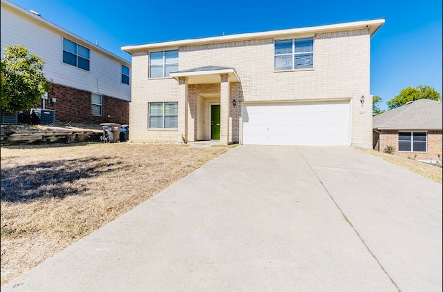 view of front of home with a garage and cooling unit