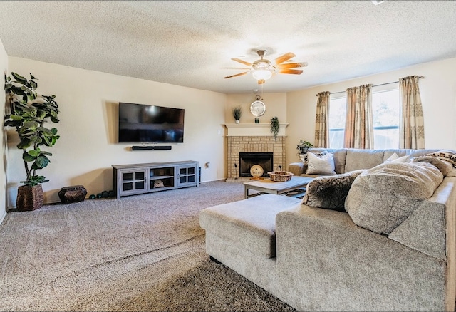 carpeted living room with ceiling fan, a textured ceiling, and a fireplace