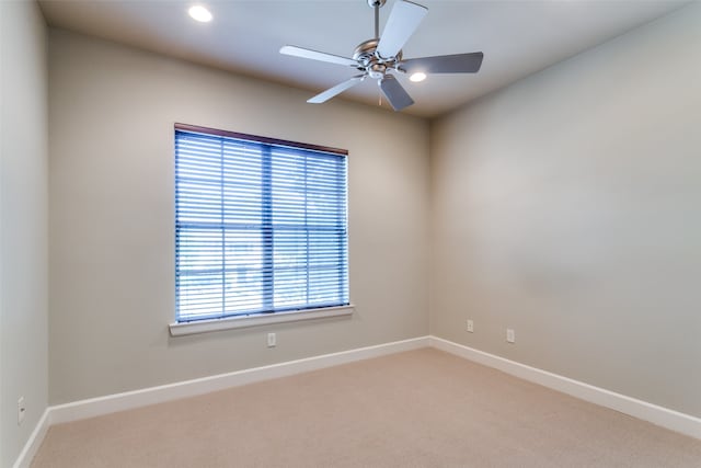 unfurnished room with ceiling fan and carpet