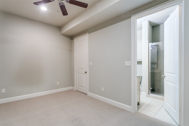 carpeted spare room with ceiling fan