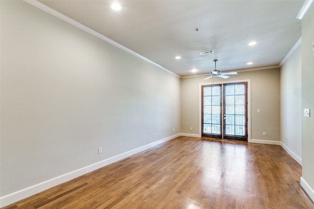 unfurnished room featuring ceiling fan, hardwood / wood-style flooring, and crown molding