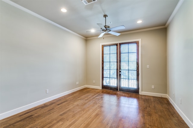 empty room with ceiling fan, hardwood / wood-style flooring, crown molding, and french doors