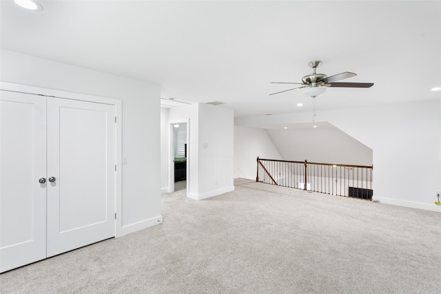 interior space featuring light colored carpet and ceiling fan