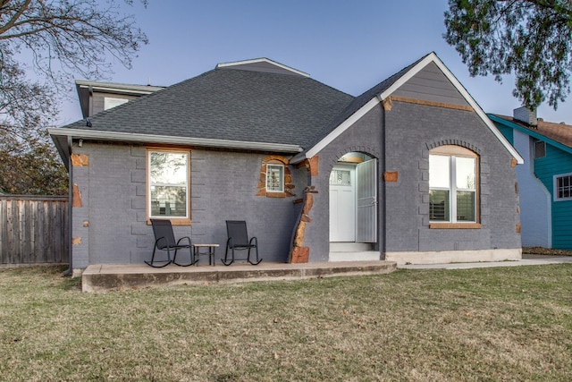 rear view of property with a lawn