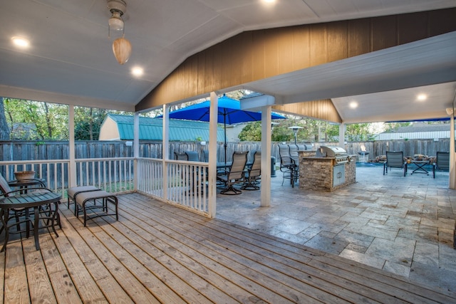 wooden deck featuring a patio and exterior kitchen