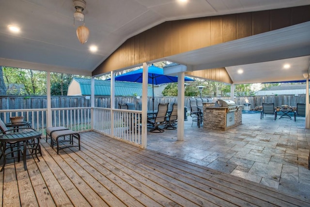 926 S Waverly Dr, Dallas, TX 75208 - wooden deck with an outdoor kitchen, a fenced backyard, a grill, and outdoor dining area