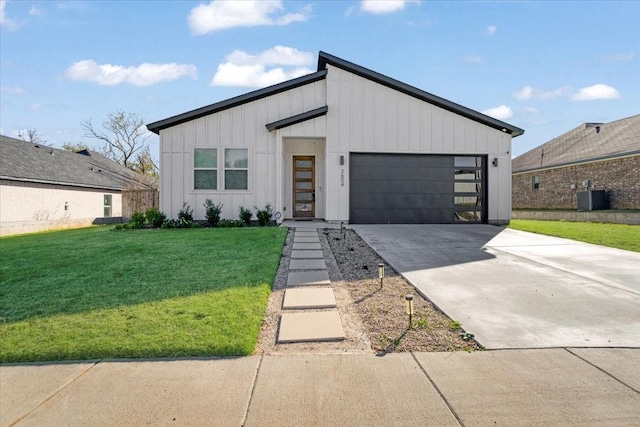 2604 Flora Ln, Denison, TX 75020 - modern home featuring board and batten siding, a front yard, concrete driveway, an attached garage, and cooling unit