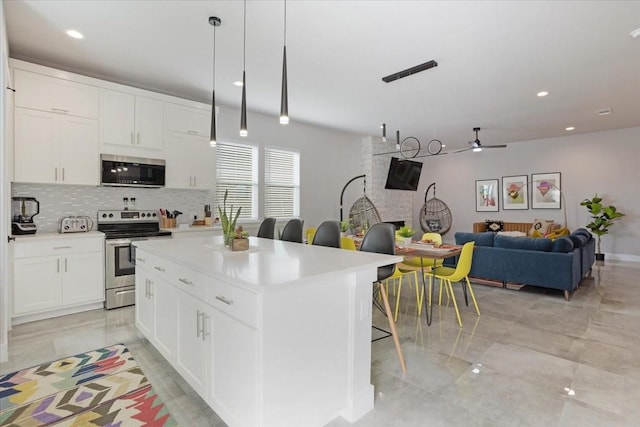 2604 Flora Ln, Denison, TX 75020 - kitchen featuring stainless steel appliances, decorative backsplash, white cabinets, a ceiling fan, and recessed lighting