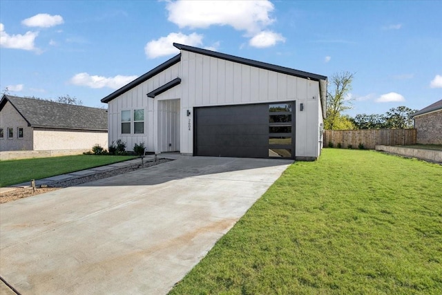 2604 Flora Ln, Denison, TX 75020 - view of front facade with board and batten siding, a garage, and driveway
