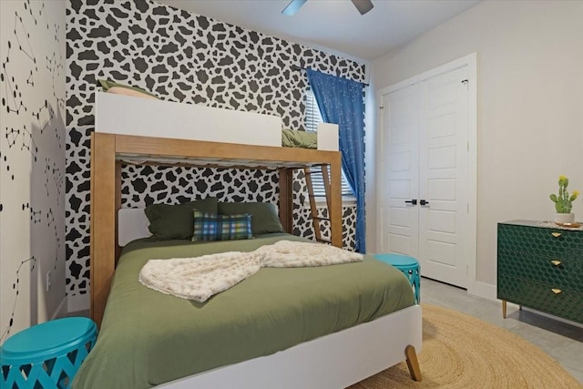 2604 Flora Ln, Denison, TX 75020 - bedroom with an accent wall, a closet, ceiling fan, and baseboards