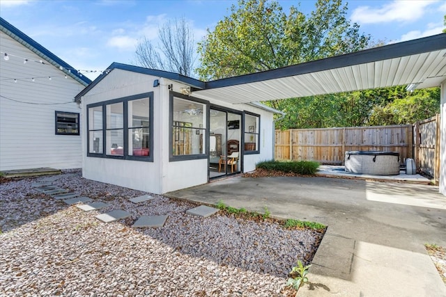 exterior space with a sunroom and a patio area