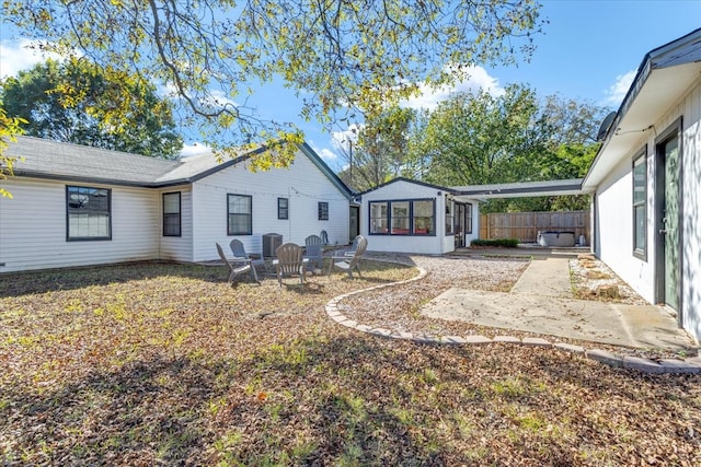 rear view of house with central air condition unit, a patio area, and a sunroom