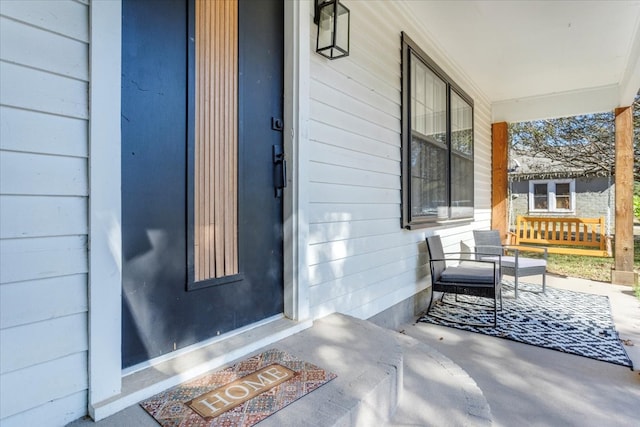 view of exterior entry with a porch