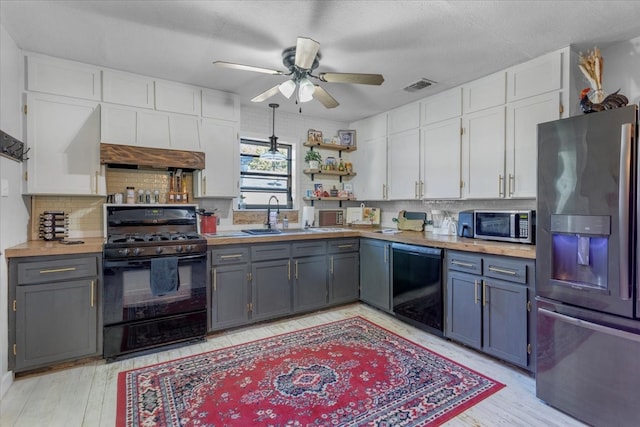 kitchen with white cabinetry, light wood-type flooring, black appliances, and gray cabinetry