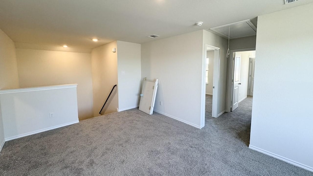 unfurnished room with dark carpet