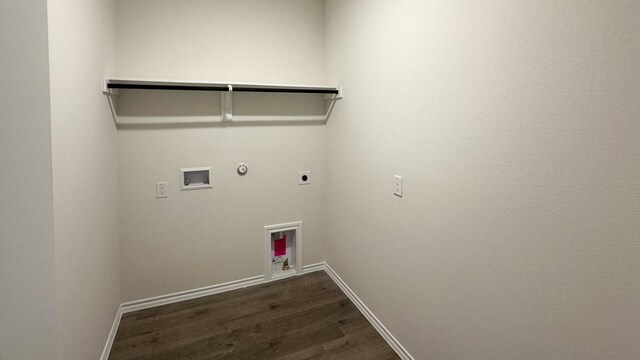 washroom featuring electric dryer hookup, hookup for a gas dryer, dark hardwood / wood-style flooring, and washer hookup