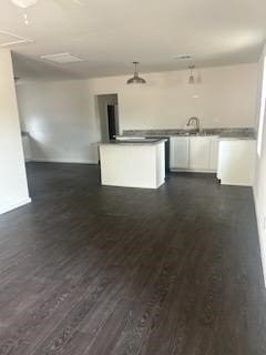 kitchen featuring white cabinetry and dark hardwood / wood-style flooring