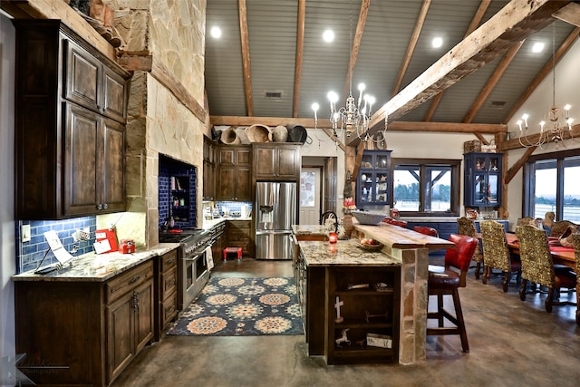 kitchen featuring stainless steel fridge, high vaulted ceiling, an inviting chandelier, and a spacious island