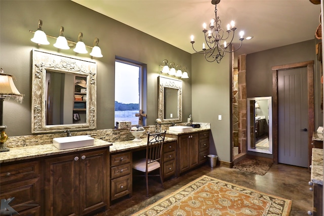 bathroom featuring concrete floors, an inviting chandelier, and vanity