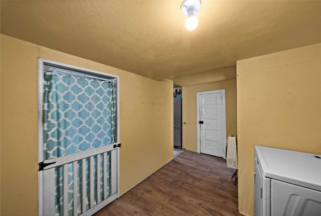 interior space featuring a textured ceiling, washer / clothes dryer, and dark hardwood / wood-style flooring