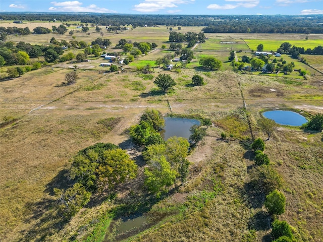 drone / aerial view featuring a water view and a rural view