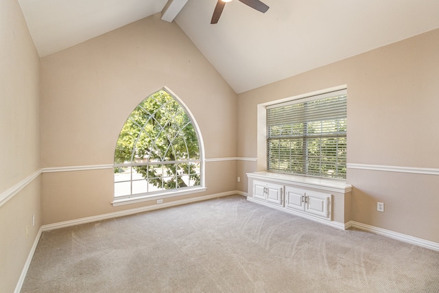 spare room with light carpet, lofted ceiling with beams, and ceiling fan