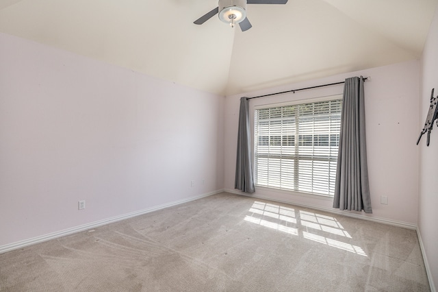 carpeted spare room with ceiling fan and high vaulted ceiling