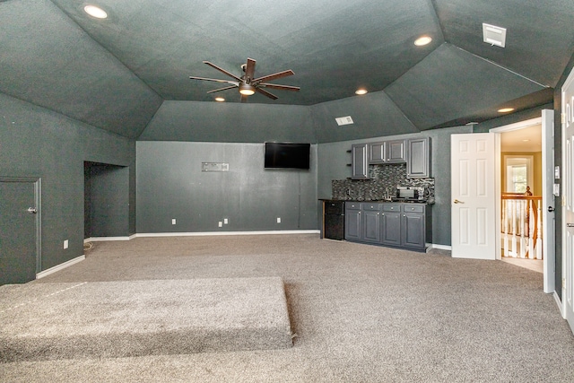 unfurnished living room featuring lofted ceiling, ceiling fan, and carpet floors