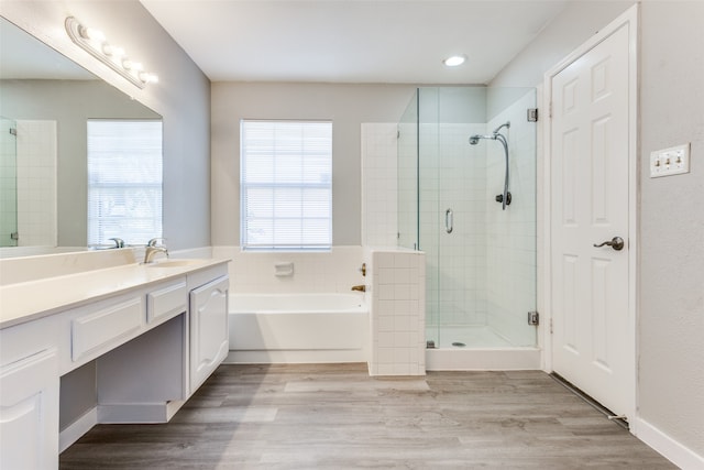 bathroom featuring vanity, shower with separate bathtub, and hardwood / wood-style flooring