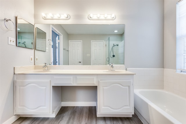 bathroom with vanity, shower with separate bathtub, and hardwood / wood-style flooring