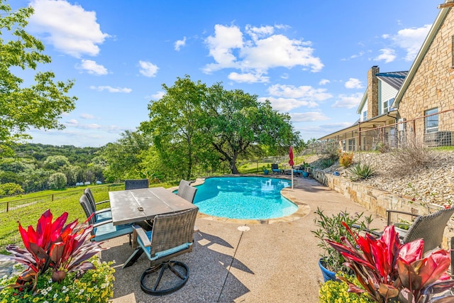 view of swimming pool with a patio area