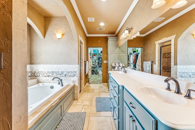 bathroom with ornamental molding, vanity, and a bath