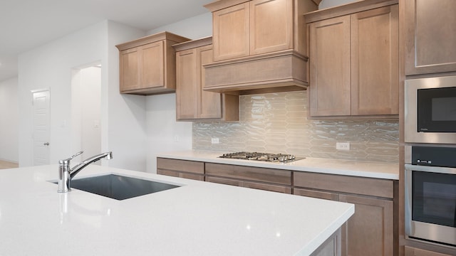 kitchen featuring sink, backsplash, and appliances with stainless steel finishes