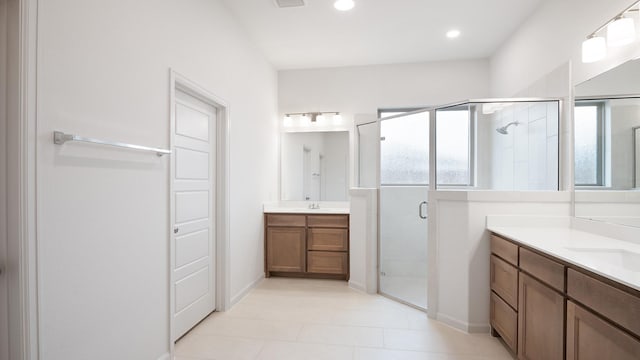 bathroom with vanity, tile patterned flooring, and walk in shower