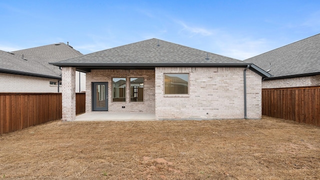 back of property featuring a yard and a patio area