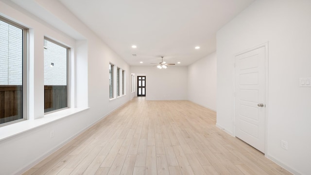 spare room with ceiling fan and light hardwood / wood-style flooring