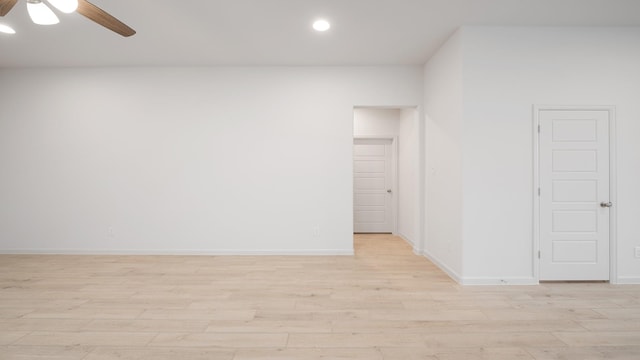 spare room with ceiling fan and light wood-type flooring