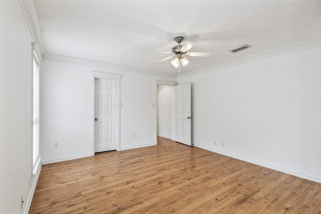 empty room featuring ceiling fan, light hardwood / wood-style flooring, and ornamental molding